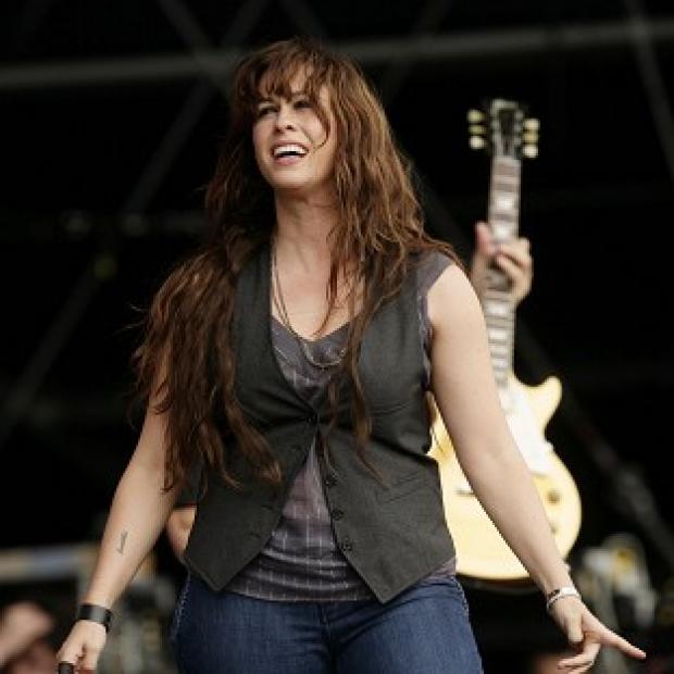 Alanis Morissette said it wasn't easy penning music while she was expecting