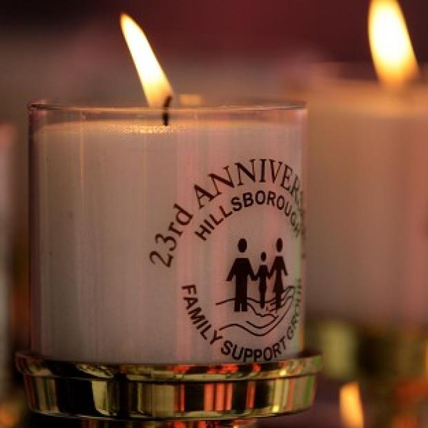 Candles burn during a Hillsborough stadium tragedy memorial service at Liverpool's Anfield