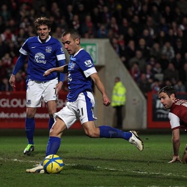 Leon Osman, centre right, fires in Everton's third goal in the FA Cup third round