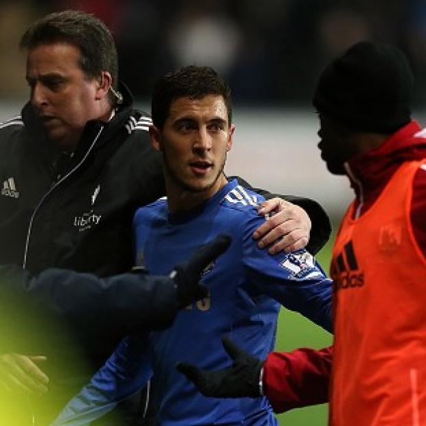 Eden Hazard, centre, leaves the pitch after being sent off against Swansea