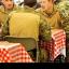 Prince Harry eats with fellow air crew in the dining facility at Camp Bastion