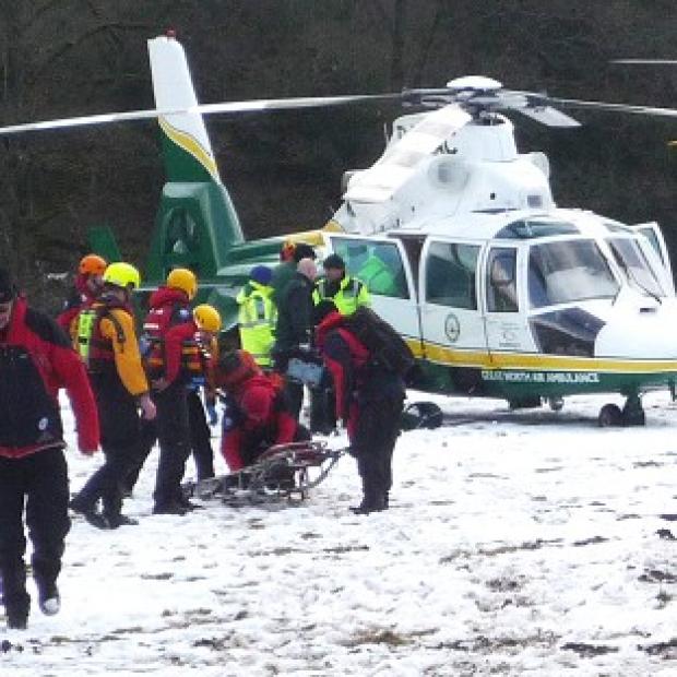 Emergency workers at the scene at the River Swale at Reeth, in the Yorkshire Dales, where a canoeist, who has since died, was rescued