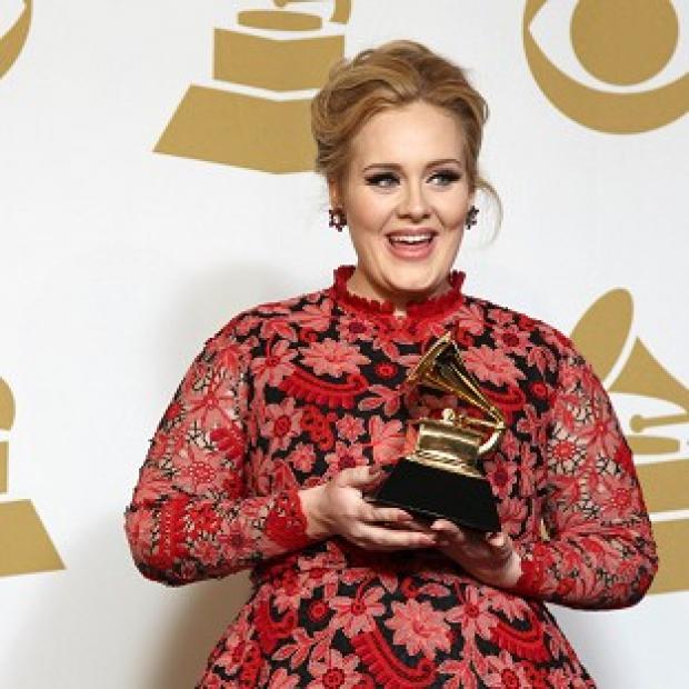 Adele with the award for best pop solo performance for Set Fire to the Rain at the 55th annual Grammy Awards (Invision/AP)