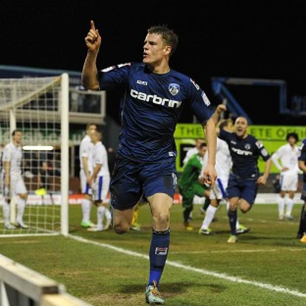 Matt Smith celebrates scoring Oldham's equaliser against Everton