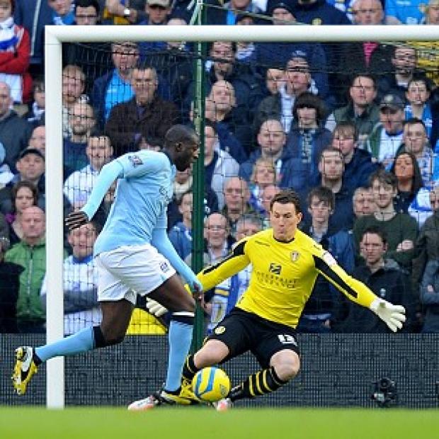 Yaya Toure, left, scores Manchester City's opening goal against Leeds United