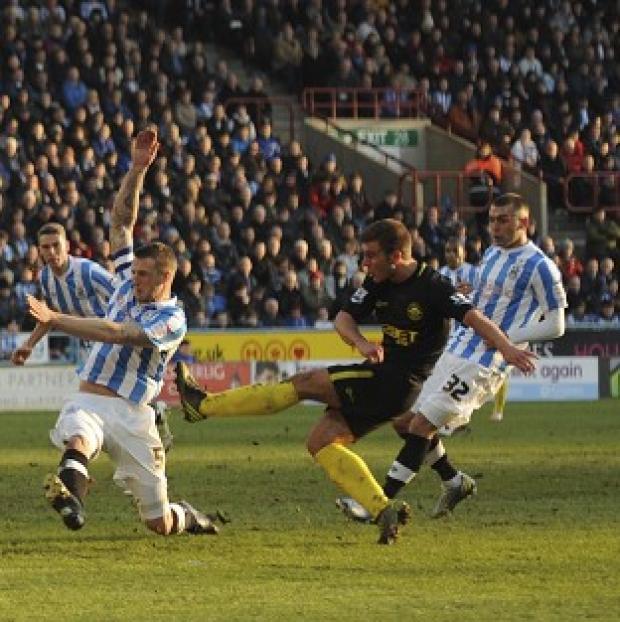 Callum McManaman, centre, scores the opening goal of the game for Wigan