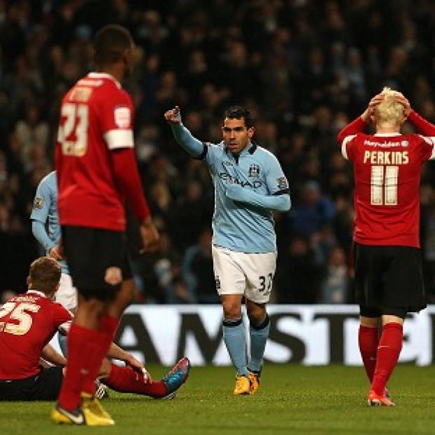Carlos Tevez, centre, celebrates scoring Manchester City's fourth and his hat trick goal