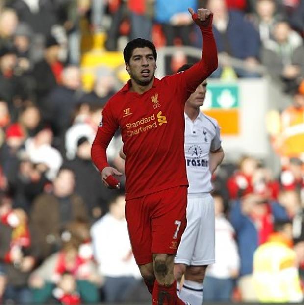 Luis Suarez celebrates netting Liverpool's opening goal in his pivotal performance at Anfield