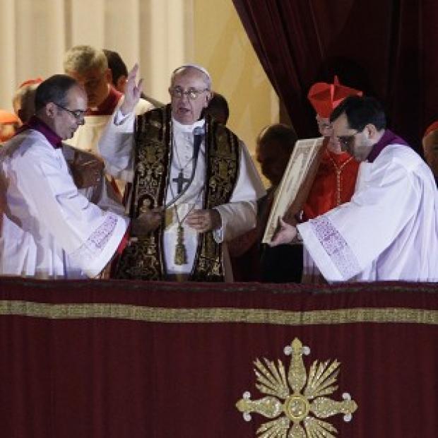 Pope Francis blesses the crowd from the central balcony of St Peter's Basilica at the Vatican (AP)