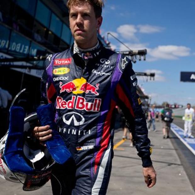 Red Bull driver Sebastian Vettel walks along the pit lane after the first practice session (AP)