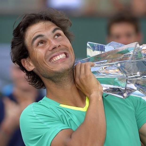 Rafael Nadal poses with the trophy after defeating Juan Martin del Potro (AP)