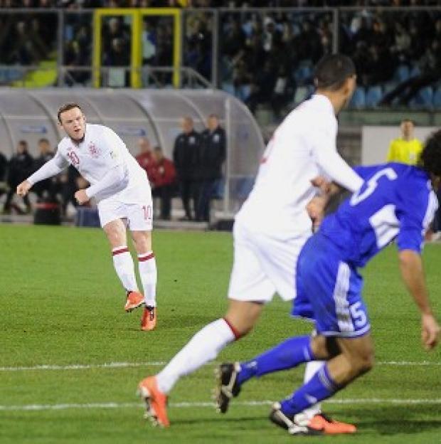 Wayne Rooney, left, curls home England's sixth goal in San Marino