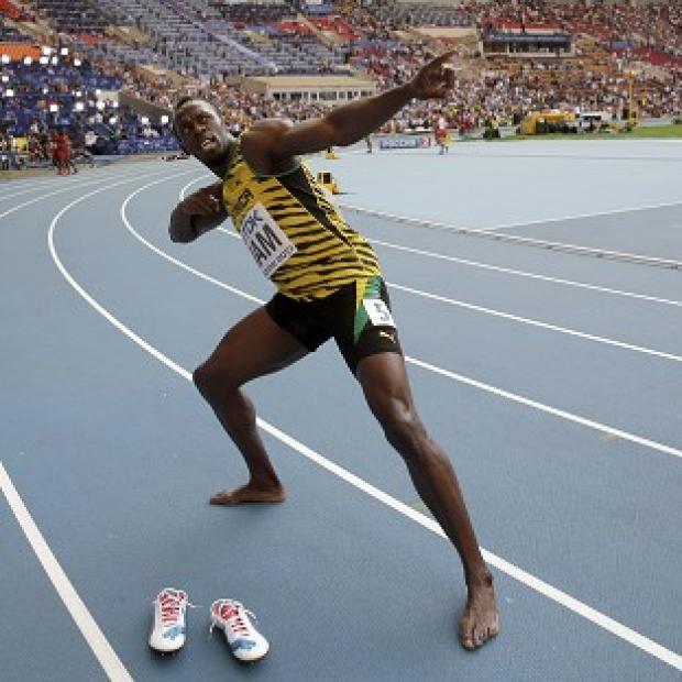Usain Bolt celebrates winning his third gold medal (AP)