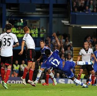 John Obi Mikel, right, stabs in his first ever league goal for Chelsea