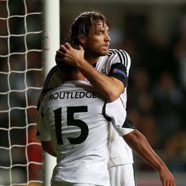 Congleton Guardian: Wayne Routledge, left, celebrates with Michu after scoring the winner Congleton Guardian: Wayne Routledge, left, celebrates with Michu after scoring the winner