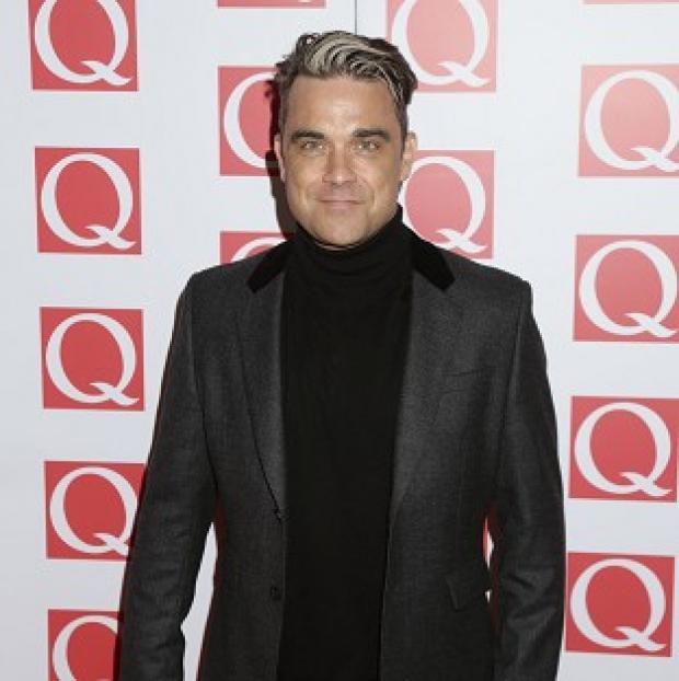 Robbie Williams was working the silver fox look at the Q Awards