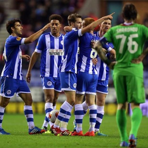 Nick Powell, centre, celebrates his goal