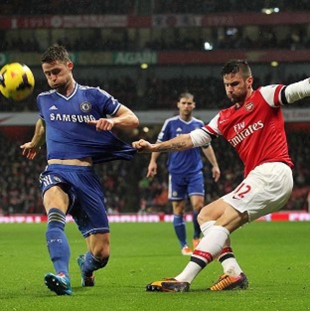 Congleton Guardian: Gary Cahill, left, tries to block a cross from Olivier Giroud Congleton Guardian: Gary Cahill, left, tries to block a cross from Olivier Giroud