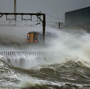 Congleton Guardian: A train is lashed by waves along the coast at Saltcoats as Scotland has been warned to expect a storm surge. Congleton Guardian: A train is lashed by waves along the coast at Saltcoats as Scotland has been warned to expect a storm surge.