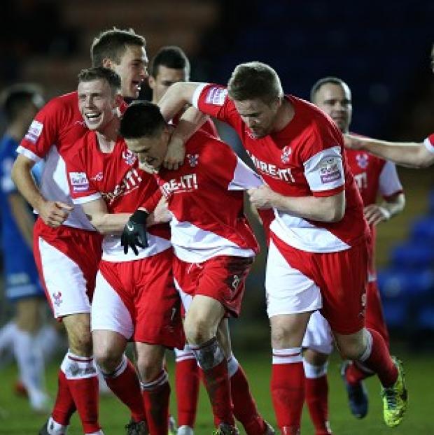 Congleton Guardian: Kidderminster players celebrate with Joe Lolley, centre, after his winning goal Congleton Guardian: Kidderminster players celebrate with Joe Lolley, centre, after his winning goal