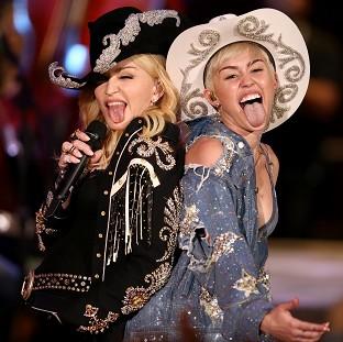 Congleton Guardian: Miley Cyrus performs with Madonna for MTV Tuesday Jan. 28, 2014. The 21-year-old pop star and the 55-year-old Queen of Pop grinded and grabbed each other as they performed Cyrus' hit "We Can't Stop" and Madonna's 2000 track "Don't Tell Me" Tuesday during Congleton Guardian: Miley Cyrus performs with Madonna for MTV Tuesday Jan. 28, 2014. The 21-year-old pop star and the 55-year-old Queen of Pop grinded and grabbed each other as they performed Cyrus' hit "We Can't Stop" and Madonna's 2000 track "Don't Tell Me" Tuesday during