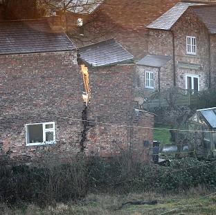 Congleton Guardian: A view of a large crack on a house in Magdalen's Close, Ripon, after a 25ft wide sinkhole opened up in the street Congleton Guardian: A view of a large crack on a house in Magdalen's Close, Ripon, after a 25ft wide sinkhole opened up in the street