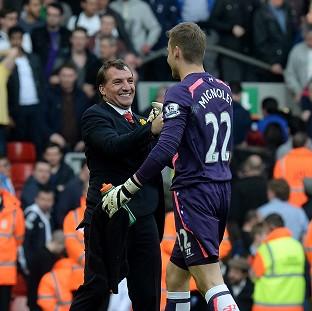 Congleton Guardian: Liverpool goalkeeper Simon Mignolet, right, has hailed the team spirit created by manager Brendan Rodgers, left Congleton Guardian: Liverpool goalkeeper Simon Mignolet, right, has hailed the team spirit created by manager Brendan Rodgers, left