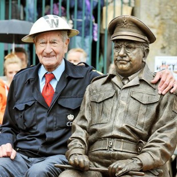 Congleton Guardian: Bill Pertwee who starred in the classic TV comedy Dad's Army sits beside at bronze statue of Captain Mainwaring, played by actor Arthur Lowe, in Thetford, Norfolk Congleton Guardian: Bill Pertwee who starred in the classic TV comedy Dad's Army sits beside at bronze statue of Captain Mainwaring, played by actor Arthur Lowe, in Thetford, Norfolk