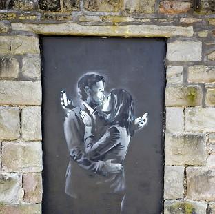 Congleton Guardian: A piece of art entitled Mobile Lovers found on a wall near a boys' club in Bristol has been confirmed as a genuine Banksy Congleton Guardian: A piece of art entitled Mobile Lovers found on a wall near a boys' club in Bristol has been confirmed as a genuine Banksy