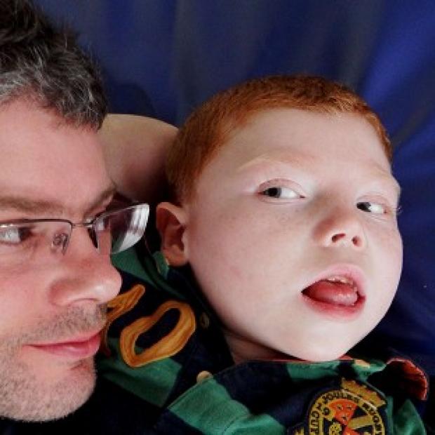 Congleton Guardian: Toby Hart with is father Matthew after a High Court judge approved a £12 million compensation agreement for the seven-year-old boy (Irwin Mitchell) Congleton Guardian: Toby Hart with is father Matthew after a High Court judge approved a £12 million compensation agreement for the seven-year-old boy (Irwin Mitchell)