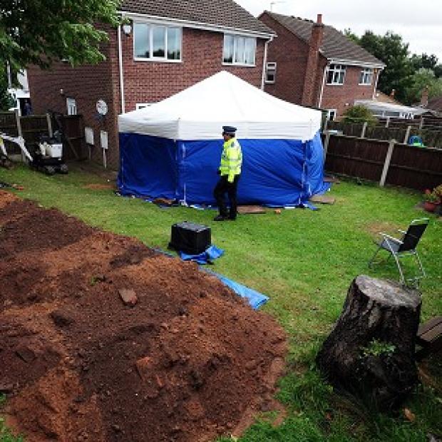 Congleton Guardian: Police in the garden of a house in Mansfield, where the remains of William and Patricia Wycherley were discovered Congleton Guardian: Police in the garden of a house in Mansfield, where the remains of William and Patricia Wycherley were discovered