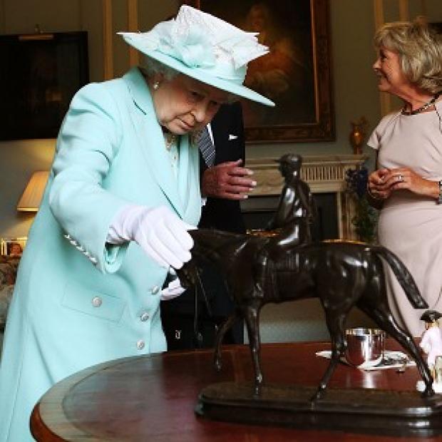 Congleton Guardian: The Queen inspects a piece by French sculptor Pierre-Jules Mene during the filming of Antiques Roadshow in Belfast Congleton Guardian: The Queen inspects a piece by French sculptor Pierre-Jules Mene during the filming of Antiques Roadshow in Belfast